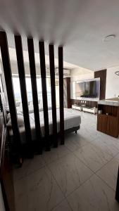 a bedroom with a bed and a large window at Suite con vista al mar Acapulco in Acapulco
