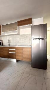 a kitchen with a stainless steel refrigerator at Suite con vista al mar Acapulco in Acapulco