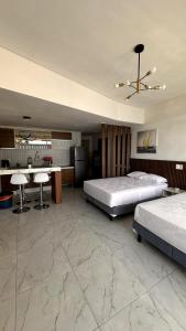 a large bedroom with two beds and a table at Suite con vista al mar Acapulco in Acapulco +19 photos