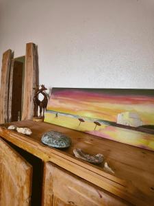 a painting on top of a wooden table at Hippie Chic - Room La Dune in Sidi Kaouki