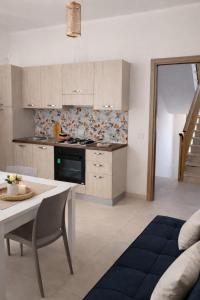 a kitchen with a table and a stove top oven at My Home Lampedusa in Lampedusa