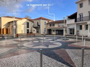 a circle in the middle of a courtyard with buildings at Biscalove in Biscarrosse