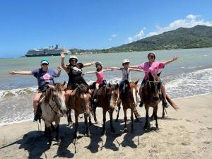 a group of people riding horses on the beach at City tours in Colorado