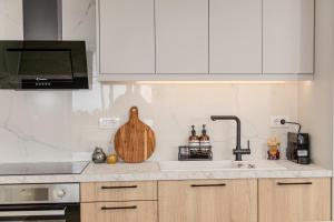 a kitchen with a sink and a counter top at Golden Horizon seafront in Goúdhouros +21 photos