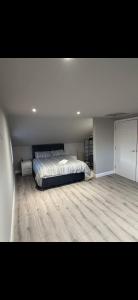 a bedroom with a bed and a wooden floor at The Arch apartment in Bangor