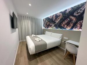 a hotel room with a bed with a painting on the wall at HOTEL BESTPRICE Maragall in Barcelona +15 photos