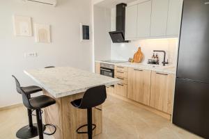 a kitchen with a counter and a refrigerator at Golden Horizon seafront in Goúdhouros