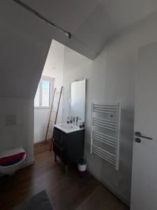a bathroom with a sink and a mirror at Loc' Maria - Grands Sables in Groix