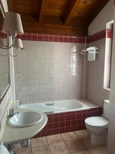 a bathroom with a tub and a toilet and a sink at Casa de La Consentida in Elciego