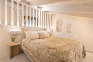 a bedroom with a large bed and a window at Pythagoreio Blue Street Upper Floor Apartment in Pythagoreio