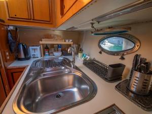 a kitchen with a stainless steel sink in an rv at Master&Commander in Valencia +50 photos
