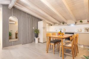 a kitchen and dining room with a table and chairs at Pythagoreio Blue Street Upper Floor Apartment in Pythagoreio