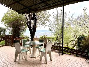 a table and chairs on a patio with a view at Su da noi in San Dorligo della Valle