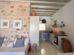 a living room with a couch and a kitchen at Agnanti Beach House in Patmos