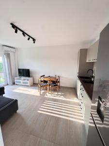 a kitchen and a dining room with a table in a room at Studio in 2 Mai,Quiet,Spacious,Garden,Separate Bedroom - Donilads Properties - Home Everywhere in 2 Mai