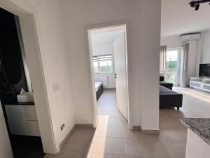 a kitchen and living room with a door leading to a living room at Studio in 2 Mai,Quiet,Spacious,Garden,Separate Bedroom - Donilads Properties - Home Everywhere in 2 Mai