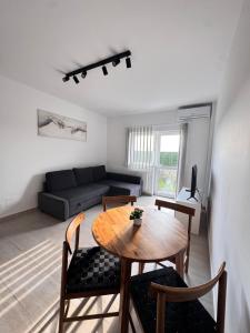 a living room with a table and a couch at Studio in 2 Mai,Quiet,Spacious,Garden,Separate Bedroom - Donilads Properties - Home Everywhere in 2 Mai +20 photos
