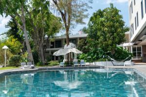 a swimming pool in front of a building at Hotel Ronda Minerva in Guadalajara