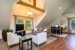 a living room with a couch and a tv at Franziska Haus in Dundee