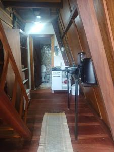 a kitchen with a staircase leading into a tiny house at Chalé Garças in Chapada dos Guimarães