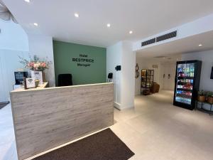 a cashier counter in a store with a green wall at HOTEL BESTPRICE Maragall in Barcelona