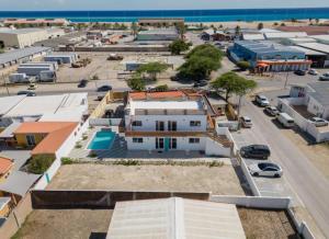 an aerial view of a town with a parking lot at Ocean Breeze in Oranjestad