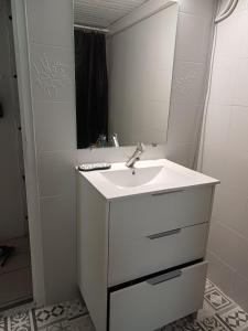 a white bathroom with a sink and a mirror at Une parenthése à la campagne in Cirey +45 photos