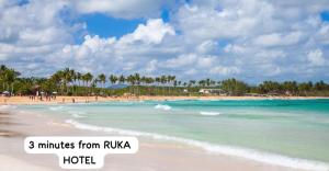a view of a beach with people in the water at RUKA Hotel in Punta Cana