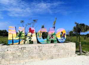 a group of colorful signs sitting on a wall at RUKA Hotel in Punta Cana