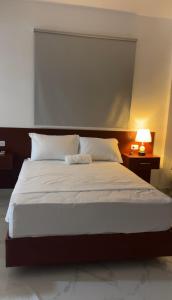 a bedroom with a large bed with white sheets and pillows at RUKA Hotel in Punta Cana +56 photos