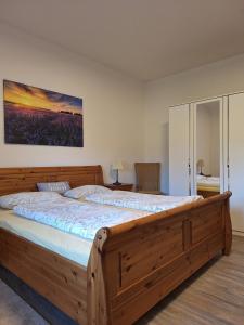 a bedroom with a large wooden bed in a room at Haus mit Seeblick in Fürstenau