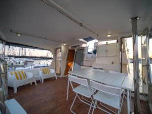 a dining area of a boat with white chairs and a table at Master&Commander in Valencia