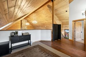 a living room with wooden ceilings and a staircase at Franziska Haus in Dundee