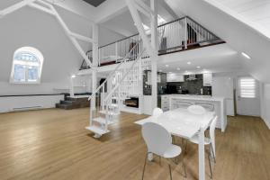 a white dining room with a white table and chairs at Maison Paris- Quartier des Spectacles in Montreal +155 photos