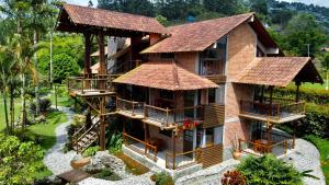 a large house with a thatched roof at Matisses Hotel & Spa in Santa Rosa de Cabal