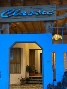 a blue sign on the side of a building at Classic Home DaHaB in Dahab