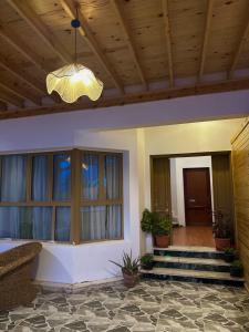 a porch of a house with a chandelier at Classic Home DaHaB in Dahab