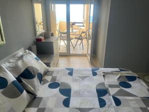 a bedroom with a bed and a view of a balcony at Apartment bay, Bougainville Bay Resort in Sarandë +42 photos