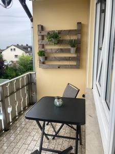 a black table on a balcony with a window at Klein aber fein in Gaimersheim