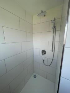 a white bathroom with a shower and a toilet at Klein aber fein in Gaimersheim +3 photos