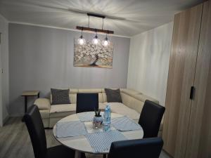 a living room with a table and a couch at Apartament Gliwice Centaura, dwa pokoje, klimatyzacja in Gliwice