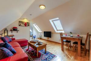 a living room with a red couch and a table at 1 Bed in Piltdown oc-t36330 in Fletching