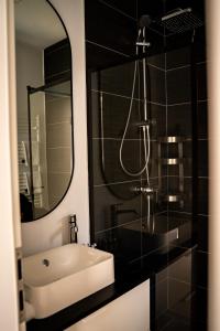 a bathroom with a sink and a mirror at Studio in 2 Mai,Quiet,Spacious,Garden,Separate Bedroom - Donilads Properties - Home Everywhere in 2 Mai