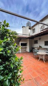 a patio of a house with a table and a bench at Arcadia entre cipreses in Pueblo Esther