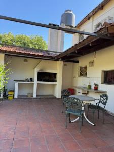 an outdoor patio with a table and chairs at Arcadia entre cipreses in Pueblo Esther +4 photos