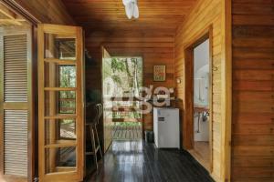 a hallway of a house with wooden walls at Suite Top – Cyclists' Paradise in Gramado