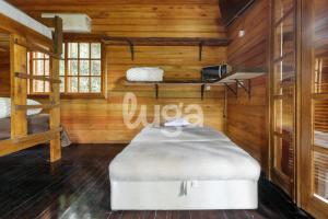 a room with a bed in a cabin at Suite Top – Cyclists' Paradise in Gramado