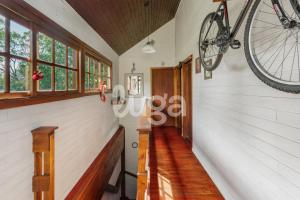 a bike hanging on the wall of a house at Suite Top – Cyclists' Paradise in Gramado
