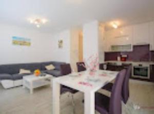 a living room with a white table and a couch at Apartment Didi in Trogir