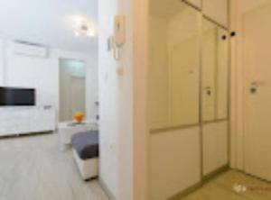 a room with a hallway with a bed and a television at Apartment Didi in Trogir
